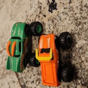 Monster jam plastic Rev up trucks has paper stickers ripping 2 cars
